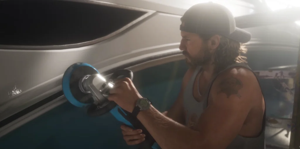 Jason uses a powered polishing tool on the exterior of a boat in the GTA 6 launch trailer.
