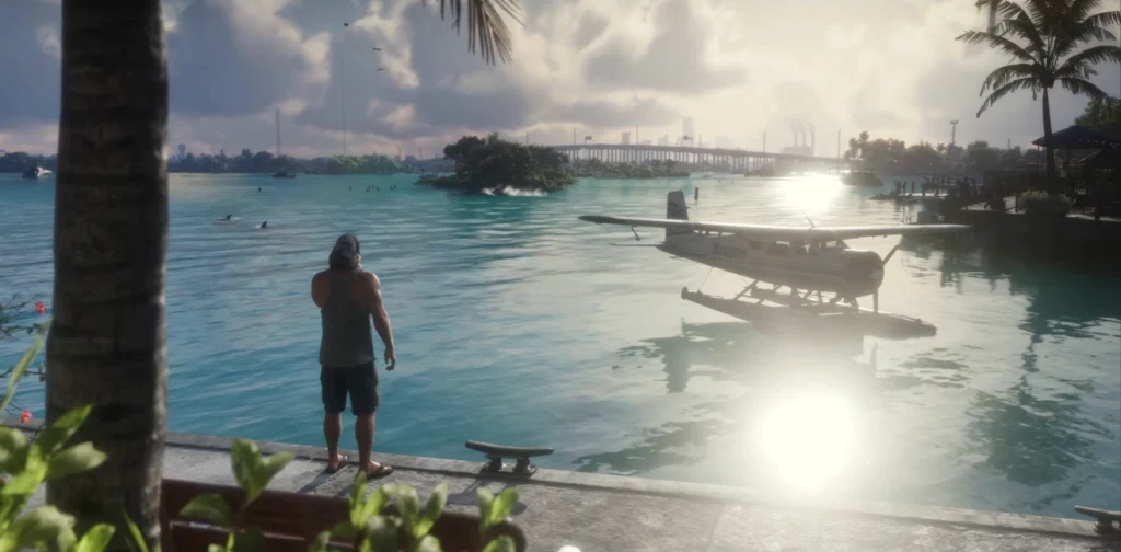 Jason stands beside the water with boats and a coastal landscape in the background.